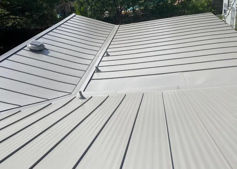 Solar attic fan installed on a metal roof for Roof Ventilation in Essex