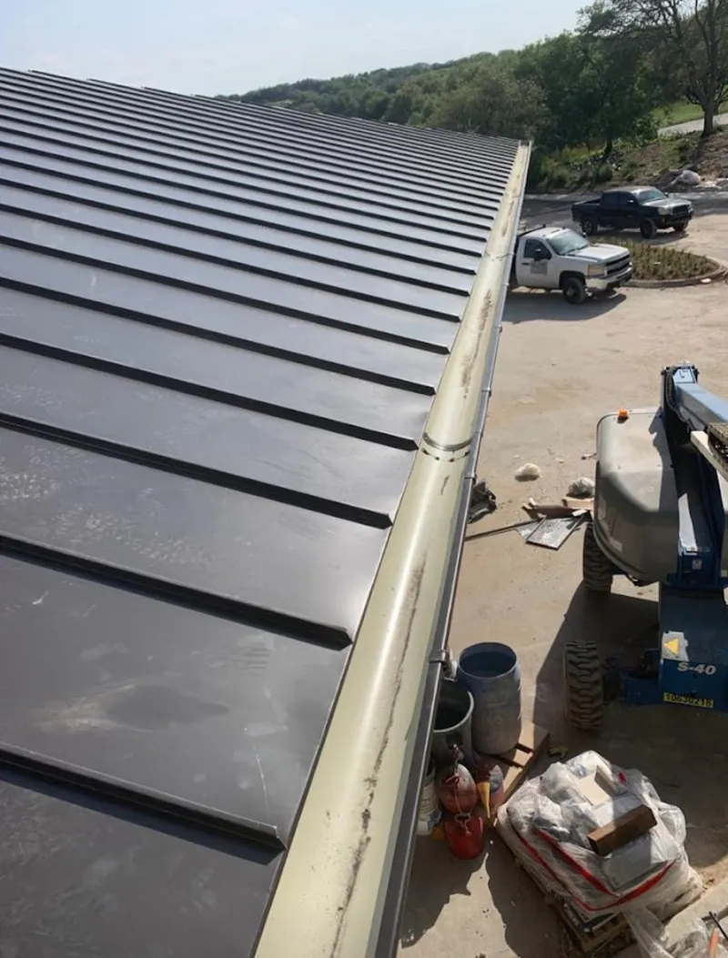 Standing seam panel and gutter detail on a metal roofing jobsite in Essex